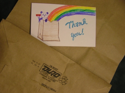 Postcard with panda, rainbow, and flowers, coming out of paper bag