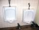 urinals -- lots of writing at eye level