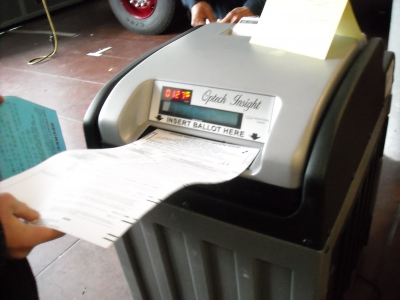 putting the ballot in the machine! how exciting!