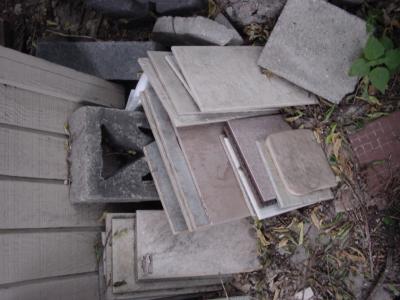 Tiles, leaning against the garage