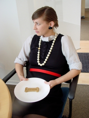 J with a bone and faux pearls.