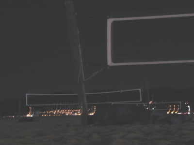 Homeless guys under a volleyball nets