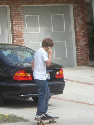 Skate boarding while on the phone Skate boarding while on the phone