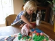 Dipping a lollipop in frosting