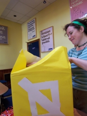 Metatron opens the wrapping to uncover.. a box! Happy Present Day!