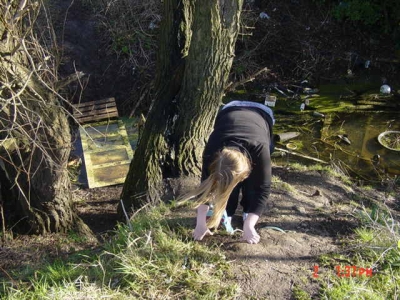 Braving the steep muddy cliff