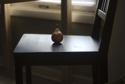 A rare pear sits in a chair