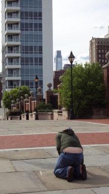 Angela writing her "love" note with the Comcast building in the background