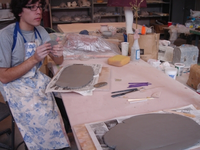 working on slabs of wet clay