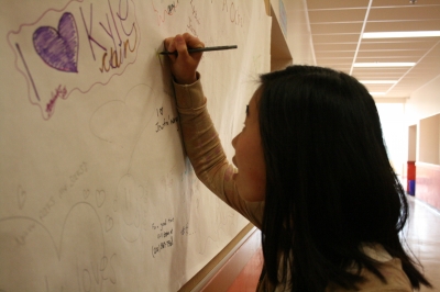 Angela writing on the first sheet.