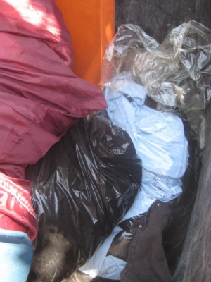 an entire trash bin full of clothes