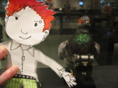 Flat Stanley has turned a defenseless pigeon into a camera-wielding cyborg! Flat Stanley has turned a defenseless pigeon into a camera-wielding cyborg!