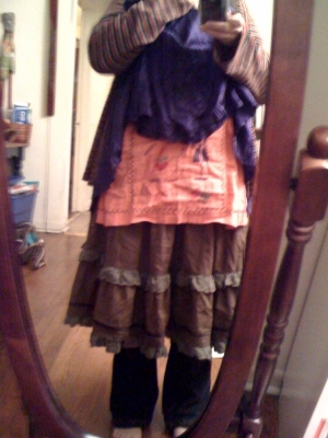 pink apron over three skirts and jeans