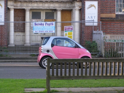 A pink SMART car