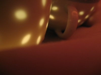 candles in tea cups on skin