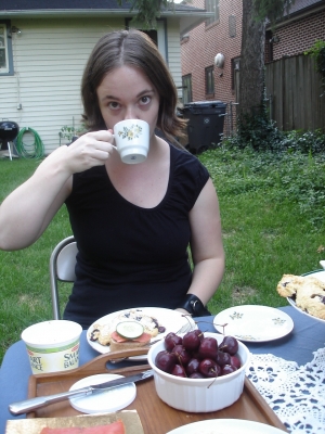 Vlo Grrl attempts to sip tea daintily.