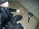 Wednesday preparing to tie a broken light to a utility pole.