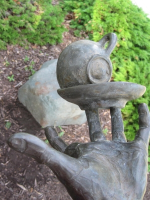 The jester looks towards his hand