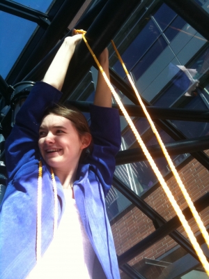 Pixie tying the swing to the crossbeam Pixie tying the swing to the crossbeam