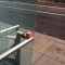 Balanced on a bus stop rail.