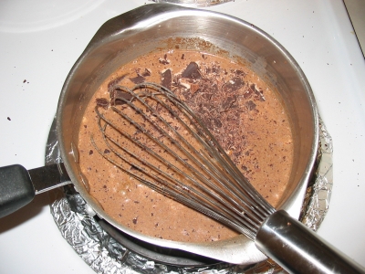 chocolate burns at very low temperatures, so bring your milk down to around 95 degrees, and work it in slowly