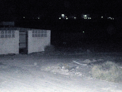 Road to the dumpster (to the right of the white ediface)