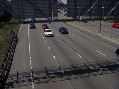 The duo traverses a freeway.
